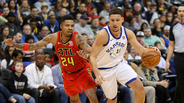 Mar 2, 2018; Atlanta, GA, USA; Atlanta Hawks guard Kent Bazemore (24) defends Golden State Warriors guard Klay Thompson (11) in the first quarter at Philips Arena.